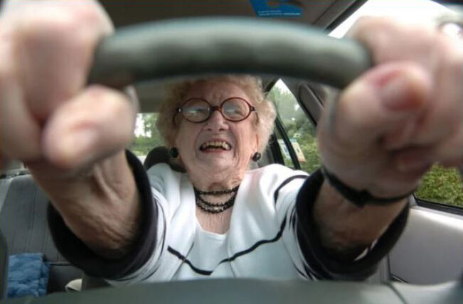 An old woman was driving down the highway when she got pulled over by a police officer.